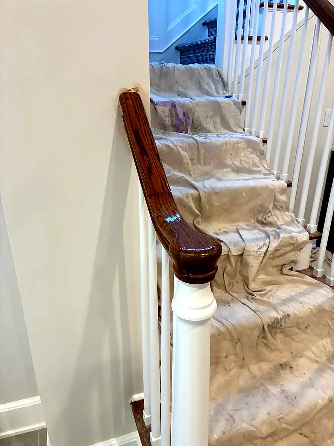 Staircase covered with protective sheeting while the floors are refinished
